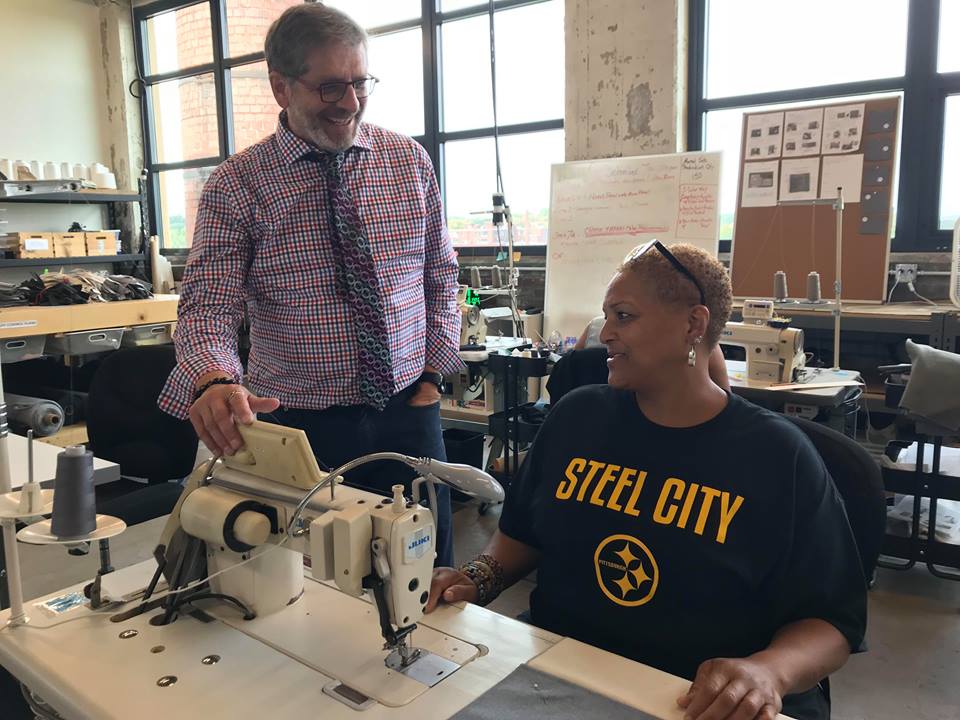 .<a href="/RonPainterNAWB/">Ron Painter</a> spent his morning at @ThreadIntl. It’s aim is to train &amp; provide employment to people in the Homewood neighborhood of #Pittsburgh. Here he's with one of the participants, who learned to sew and is now helping manufacture product.