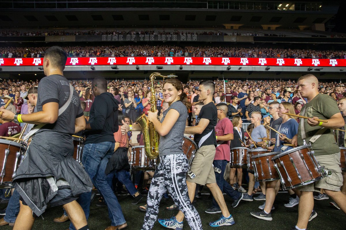 aggie band marching in and a girl with a saxophone smiling at the camera with the crowd behind them