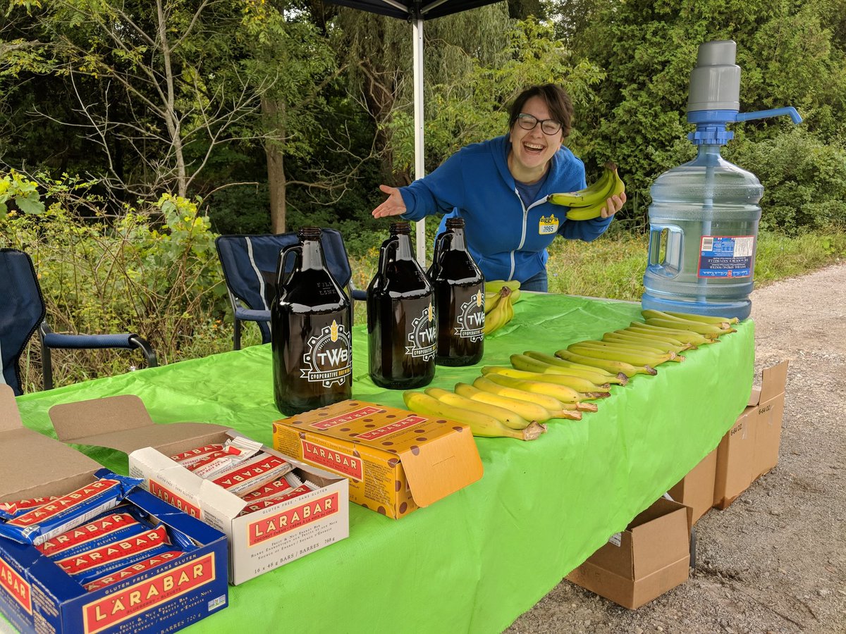 holdthelineWR's tweet photo. The good people @ZiggysCycleKW are ready at #HTL2018 first aid station for 130km route. They have bananas from @PfOrganicFarms Those @twbcoop growlers? Just water! https://t.co/J9ALWr7nkk