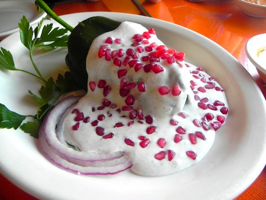 Chiles en nogada is a dish that represents Mexico: the green of the  parsley, the white of the nogada, and the red pomegranate seeds  represent the colors of our country’s flag, patriotic colors rendered to  the fortunate guest to the Independence feast bajaurl.com/ChilesNogada