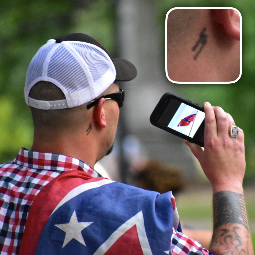 acrider's tweet photo. If it is supposed to be "Heritage Not Hate" then why do they have Nazi SS and Aryan Brotherhood (A.B.) tattoos? #SilentSam #GoHomeNazis #UNC https://t.co/Brrv4uL7iL