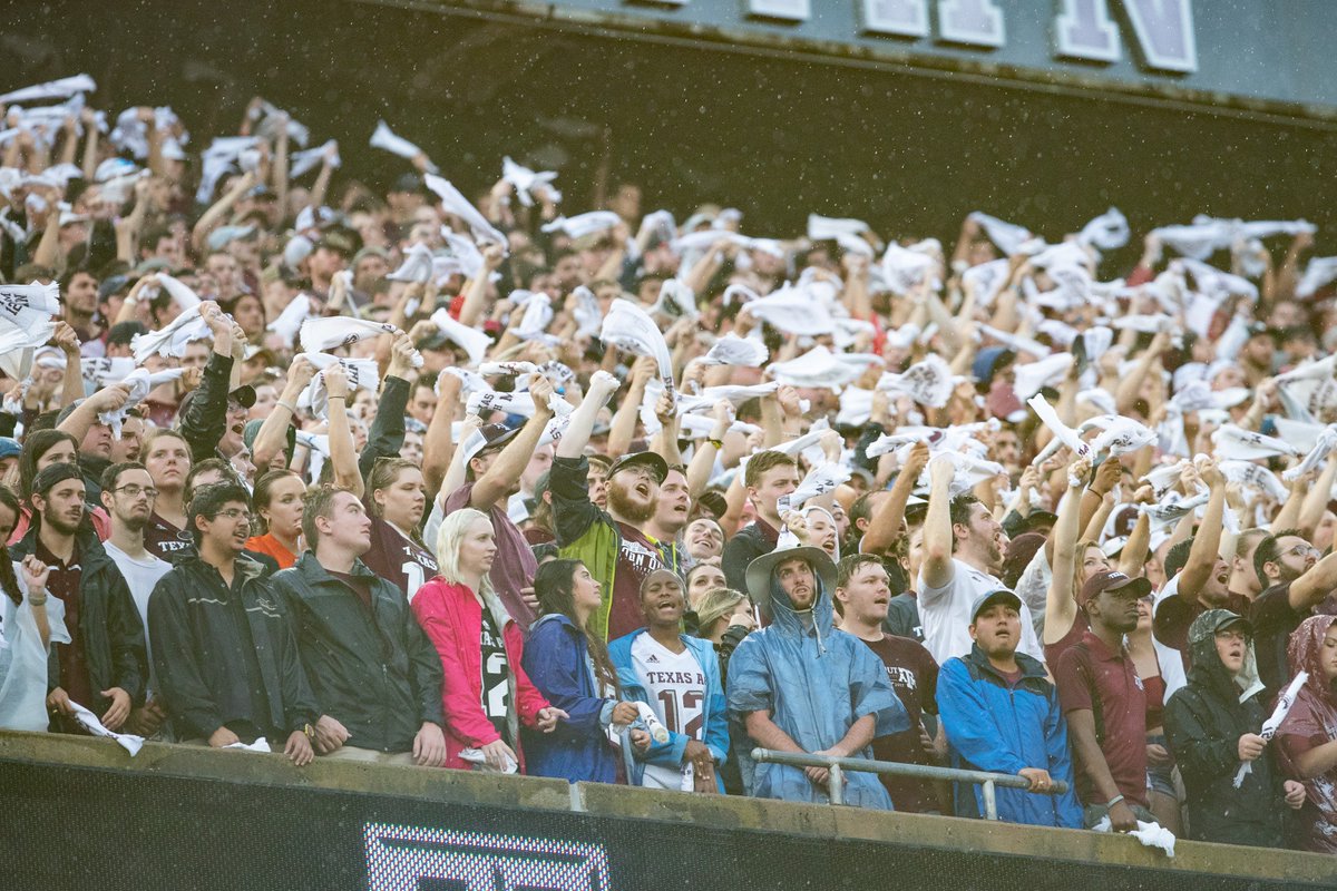 Aggies yelling and waving their towels in the rain