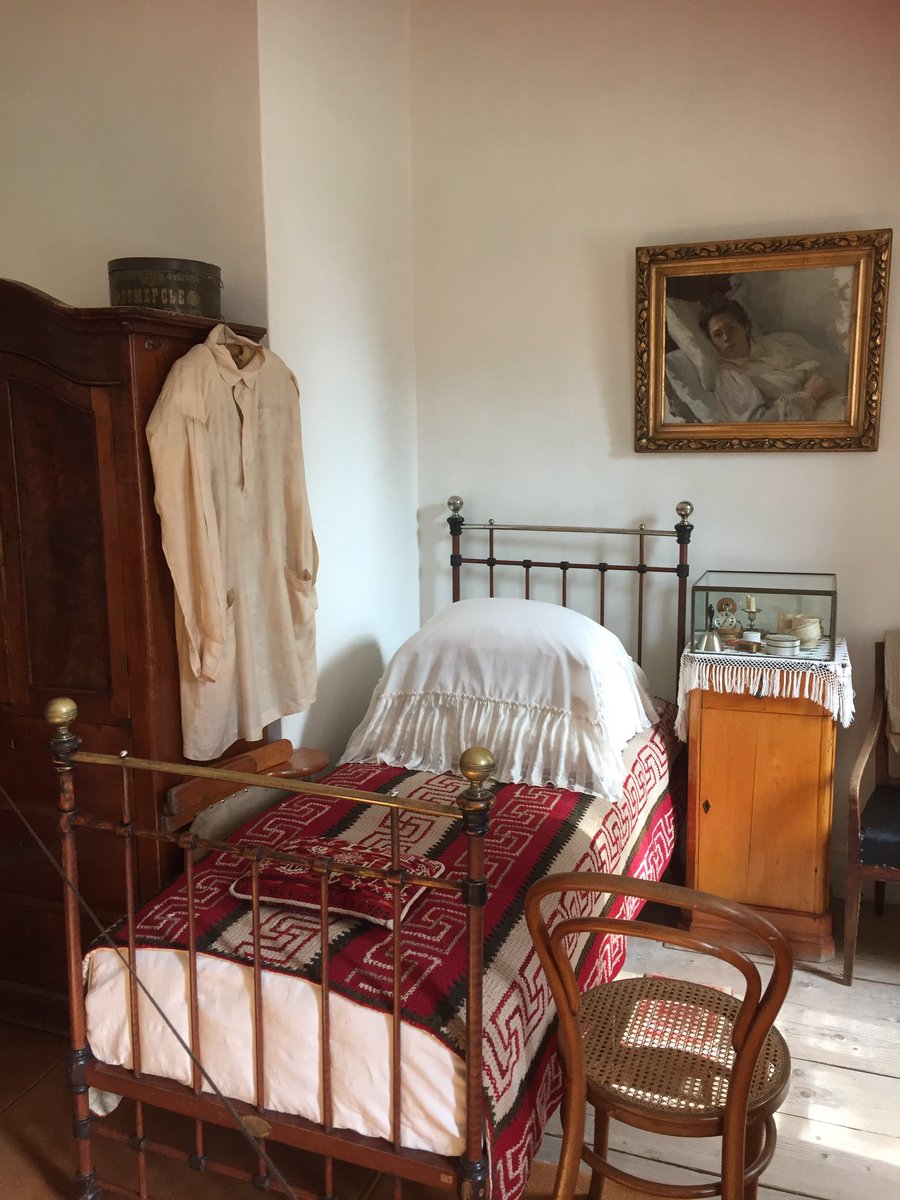 This is Tolstoy's bedroom in the last years of his life. Above it hangs a portrait of his eldest daughter, Tatiana. On the left hangs his peasant smock, which was in his own lifetime nicknamed a 'Tolstovka'