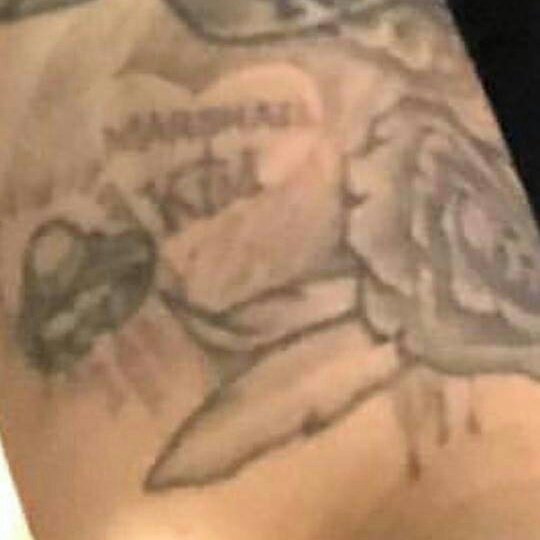 Marshall+Kim: This one is my second favorite tattoo. Below the RONNIE RIP it seems like Marshall added some roses and secrets skulls, plus the M+K. Kim is her ex wife and baby's mother. I found zero info about this tatt. This may be the proof of how deep in love he was with her.