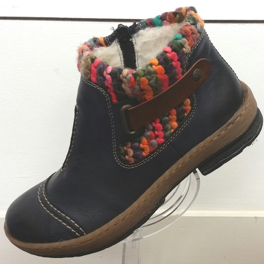 This navy and multi-coloured ankle boot features a lambswool lining, inside zip and a soft vibrant trim around the ankle. #Rieker #winterboots #ladiesfootwear #ladiesboots #boots #ladiesfashion #fashionbyrieker