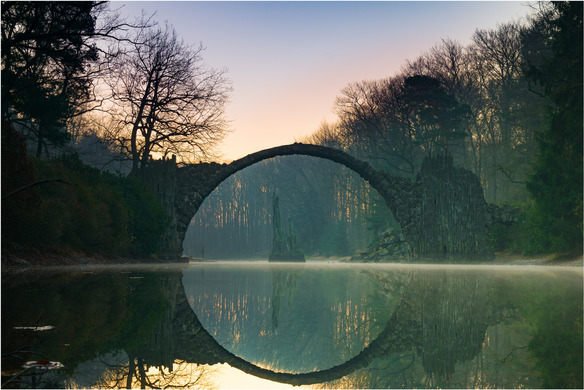 Farefetch's tweet photo. Die Rakotzbrück (Devil's Bridge) in Germany looks like a portal to another world! Spooky. https://t.co/KMF71knw3x