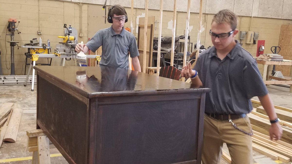 MilanCTE's tweet image. Students put the finishing touches on a desk for the MHS library. #RealProjects #improvingourschool #MilanAwesome