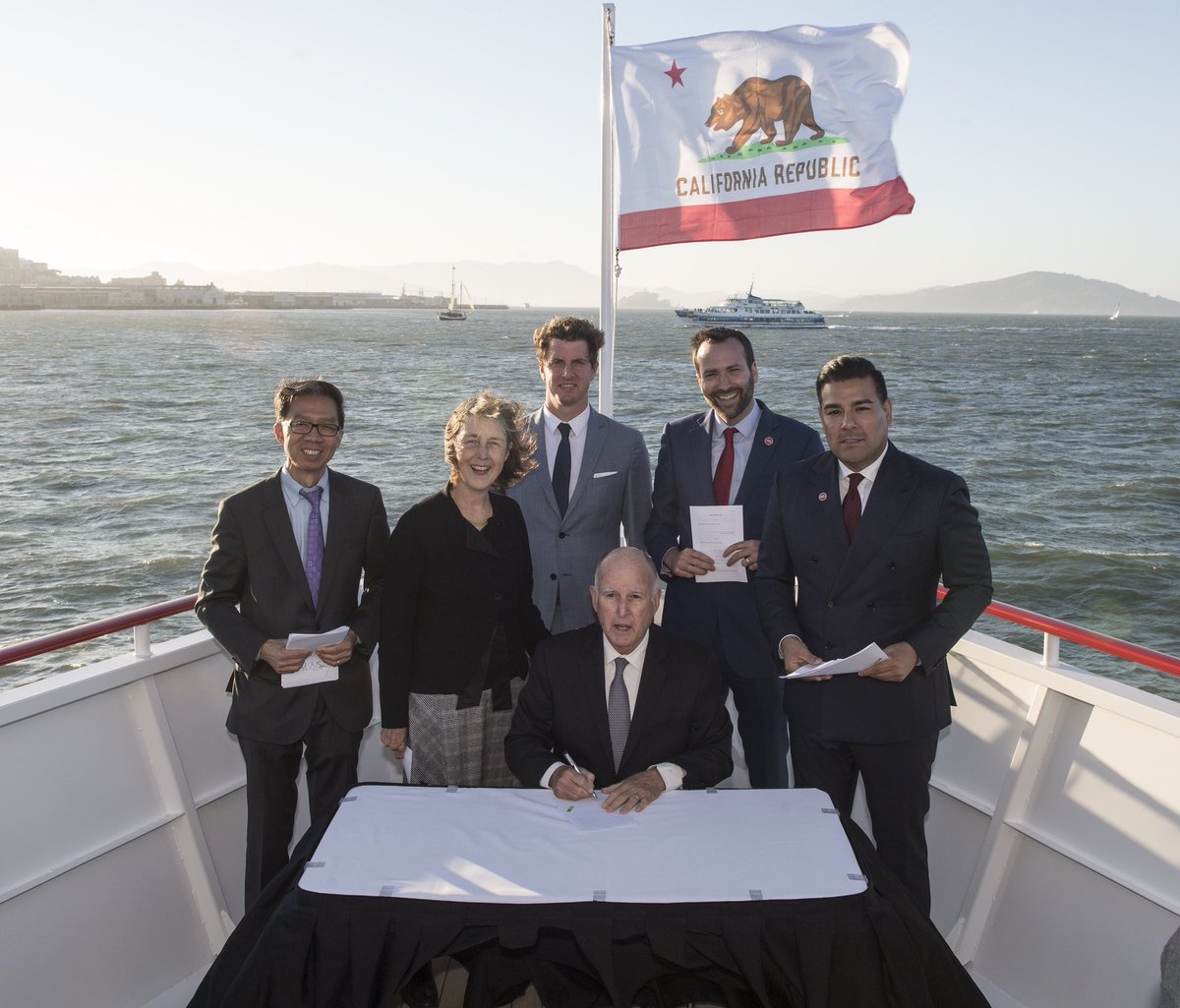 GovPressOffice's tweet photo. 🚢 All aboard for #ClimateAction: @JerryBrownGov signs a comprehensive package of climate bills while sailing on @Redwhitefleet's new plug-in hybrid electric ferry –– the first in the #BayArea. https://t.co/LNJtWS6eVs https://t.co/Ia3FRDMwyL