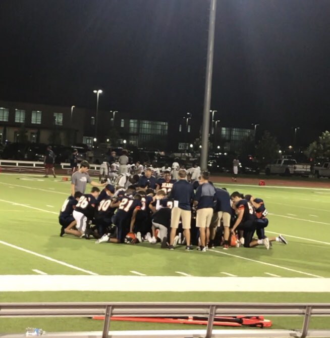 Freshman Orange kneeling to pray after their 46-0 victory #PrayAndGiveThanks #GodFamilyFootball @BridgelandFB