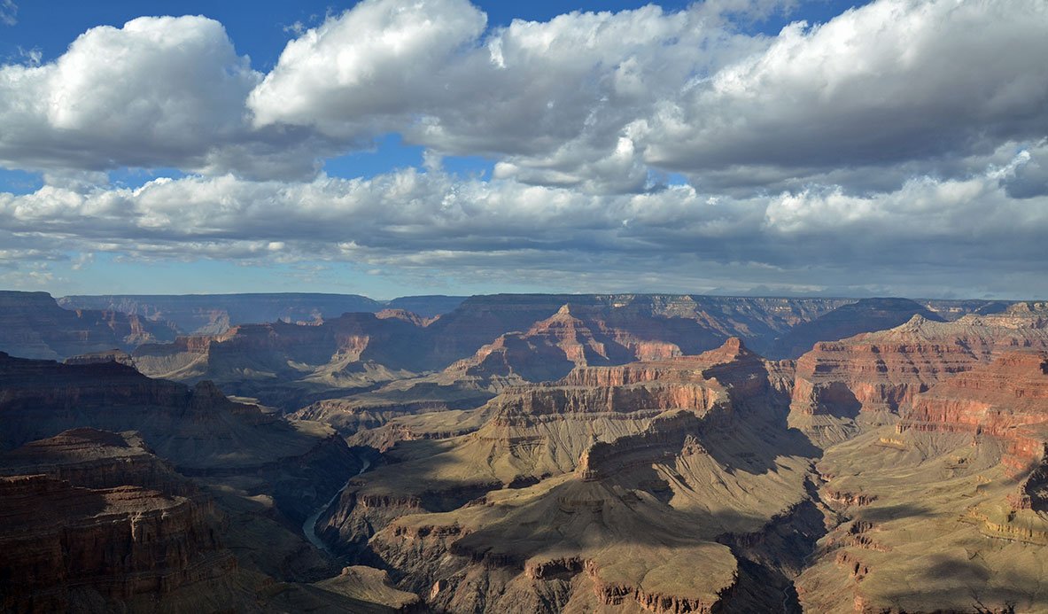 A wide shot of Grand Canyon, with clouds above.