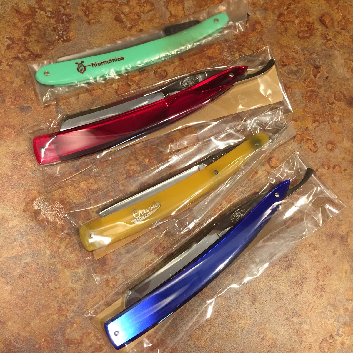 GriffithShaving's tweet photo. These lovelies are safely nestled in their sleeves with a sliver of corrosion inhibiting paper ready to go to their new shave dens. Will it be yours? #solingen #wetshaving #filarmonica #rigarazor #vintagerazor #straightrazor #shaveden #Shaving https://t.co/LUfXkNHEae