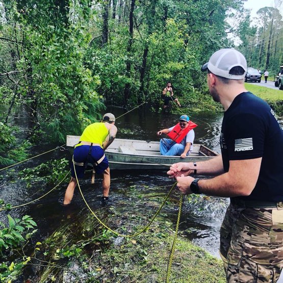 DeptofWar's tweet photo. MT @IIMefInfoGroup: #Marines assist local civilians during relief efforts while shuttling people and supplies across a damaged road in North Topsail, #NorthCarolina. #KnowYourMil https://t.co/rWQVw9RHWp