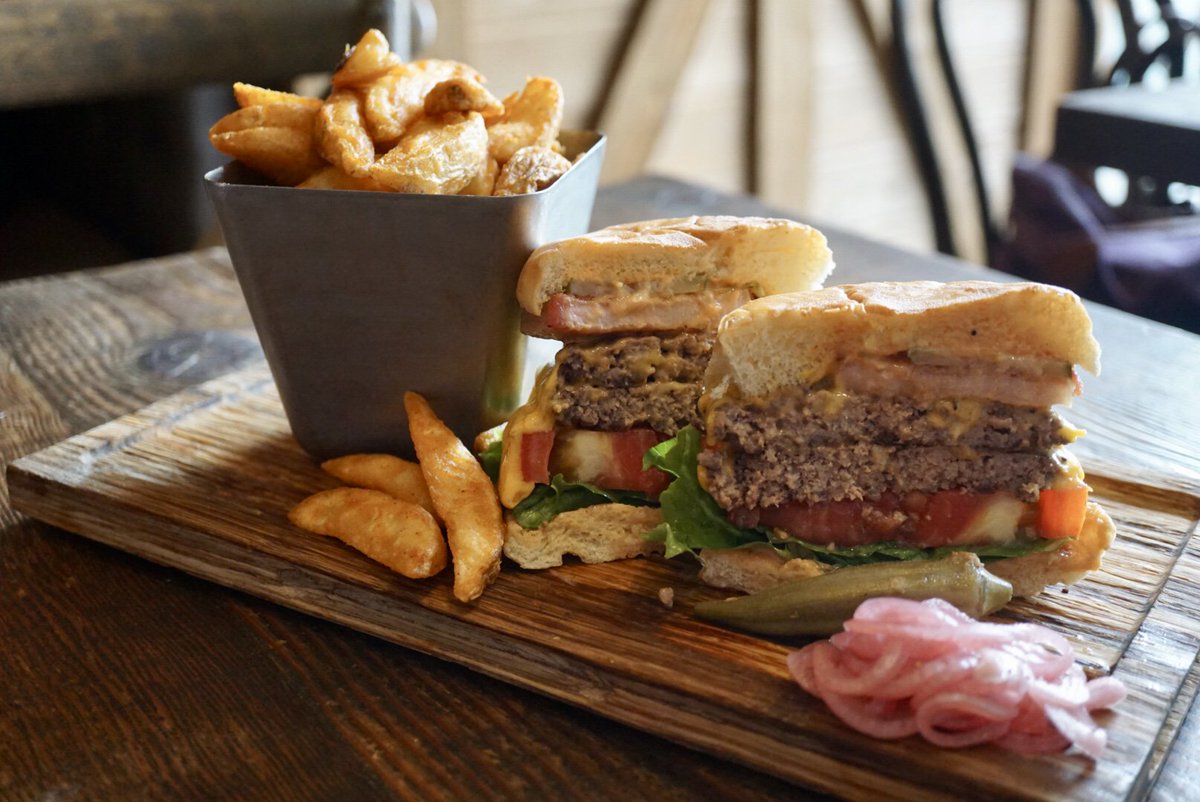 Forget the fact that it's only #Monday by biting into our delicious Swine #Burger. 🙌🍔. | 📸: @StacyMoya #YUM