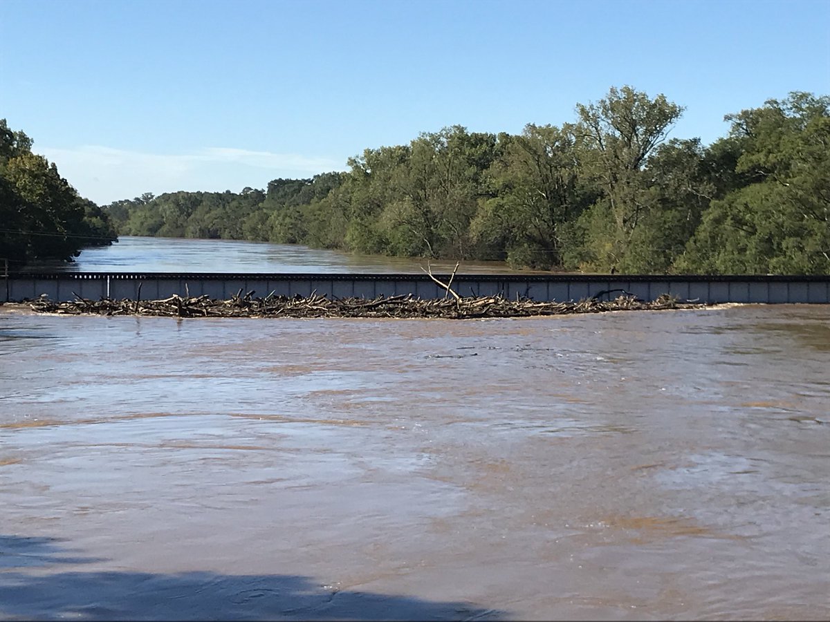 TWCAlexWallace's tweet photo. Lots of debris gathering on the side of this rail bridge that goes over the Cape Fear River in Fayetteville,NC! Some worry if it’ll be able to withstand the pressure. Just a week ago, I was standing below it, looking up, thinking “no way that water gets THAT high”. I was wrong! https://t.co/LlPzwCf9hJ