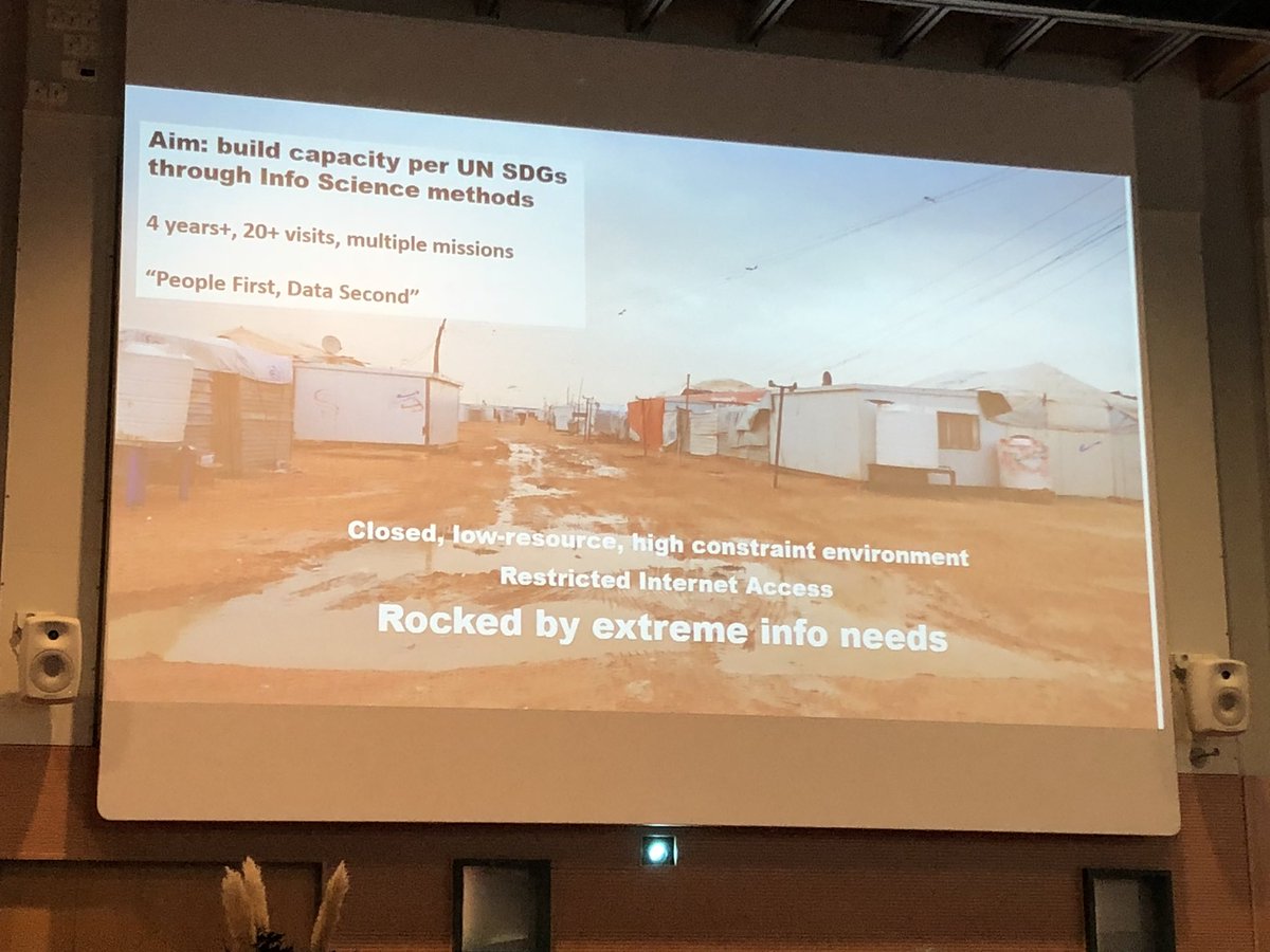 Dinamartz's tweet photo. What is information literacy in refugees in a camp? Professor Fisher discusses the Syrian refugee crisis: humanitarian ethnography at Za’Atari Camp. Trauma, disabilities, lack of education,young people. Many different businesses on social innovation, fast progress #ECIL2018 https://t.co/vjKEIpHdXE