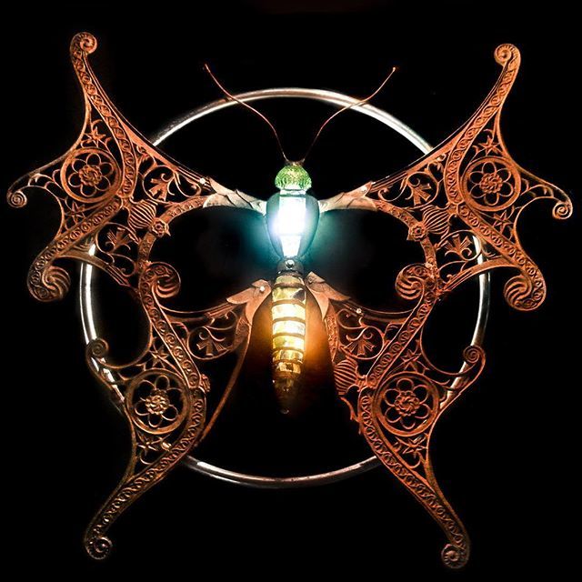 Done! The last steps were filling in the cutouts with old glass and wiring it for lights. The wings are old park benches, the circle is from a department store clothing rack, the body includes a motorcycle muffler and old fan parts, and the head is a vin… ift.tt/2PMItcN