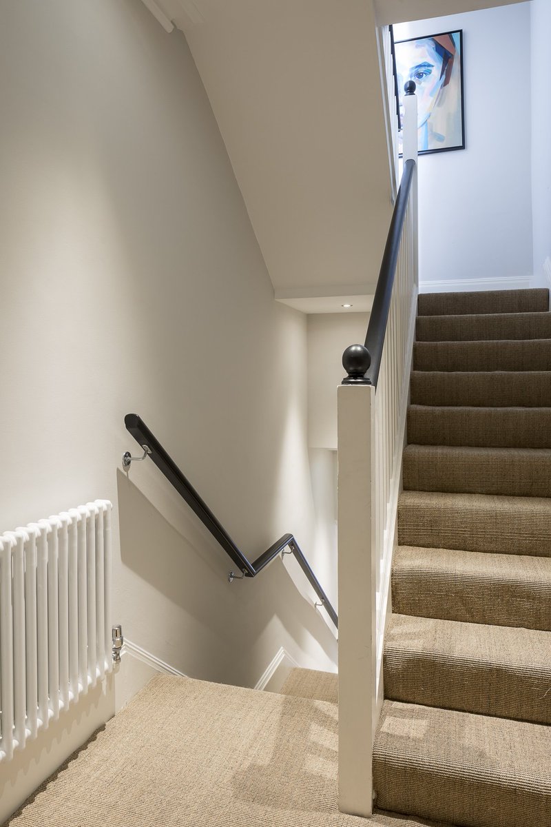 New sisal carpets and @FarrowandBall off-black handrail have smartened up this office stairway. #officedesign