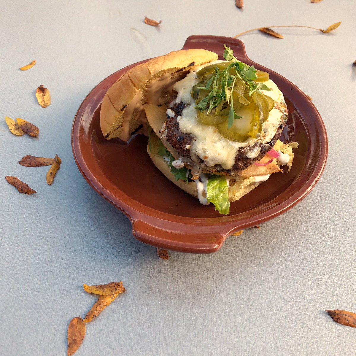 EatAlPastor's tweet photo. Half priced burger day! 🙌🏼🍔 Come try our Nacho Burger, a single beef patty on a potato roll with lettuce, fried corn tortilla, sour cream, pickled onions, chipotle aioli, pickled jalapeños and oaxaca &amp; jack cheese! (not suitable for sharing 🙃) #eatalpastor https://t.co/UHAtAwPnWG