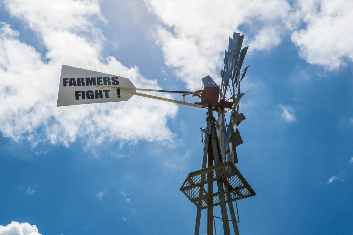 Windmill with a farmers fight sign on the tail