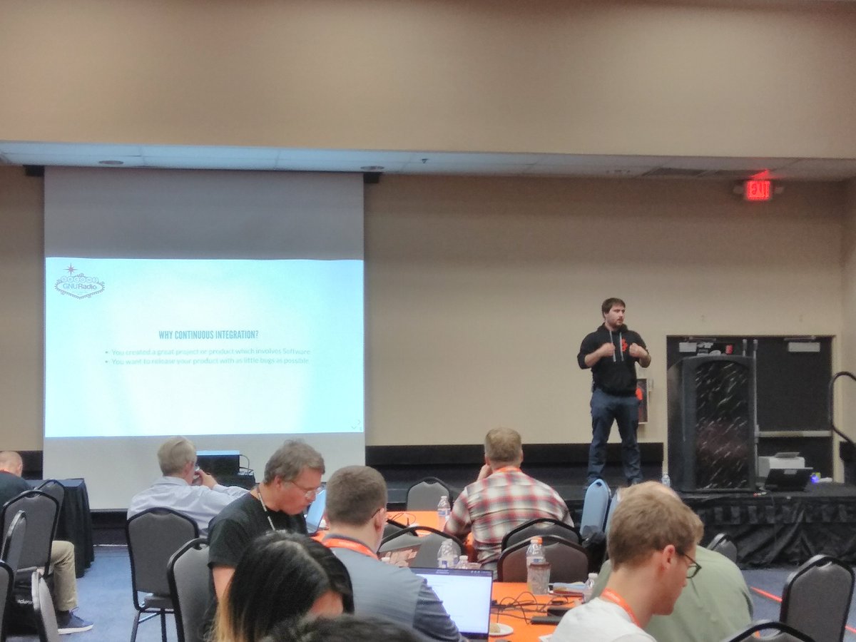 dEnergy_dTime's tweet photo. So, here's @noc0lour at #GRCon18 explains how to herd cats while having them produce high-quality, fast progressing software. He's running the @gnuradio CI infrastructure, so he's the perfect person to do that! https://t.co/6htOMrP4v4