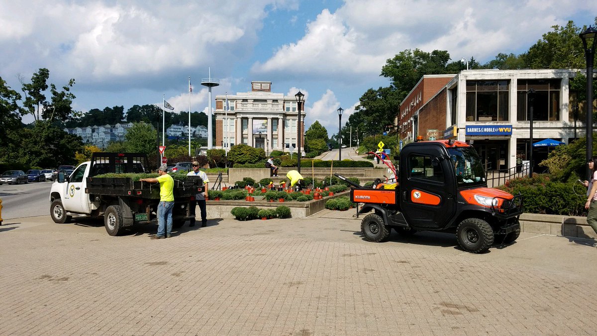 Mum"s the word!  Facilities crew working hard preparing for a colorful fall on campus with a truck load of mums.