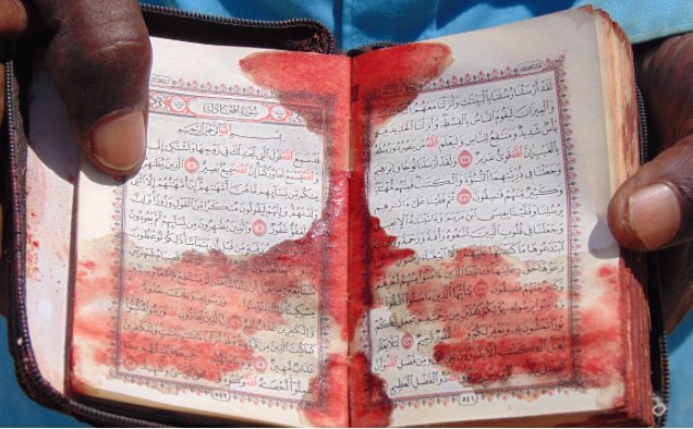 A Quran stained with the blood of children massacred in a US drone strike in Somalia that destroyed a Qur'an school and a Hospital.