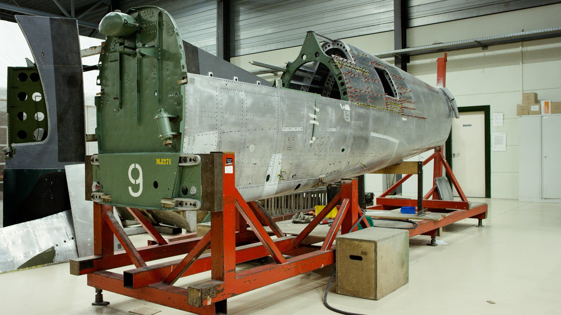 Silver Spitfire The Fuselage Of The Aircraft During An Early Stage Of The Restoration Process The Green Part At The Front Is The Firewall And The Tank At The Top Silver Spitfire The Fuselage Of The Aircraft During An Early Stage Of The Restoration Process The Green Part At The Front Is The Firewall And The Tank At The Top