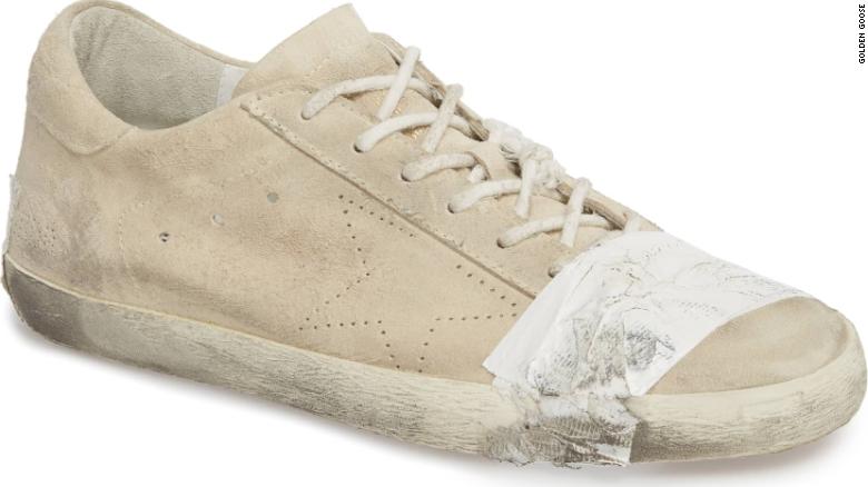 CNN's tweet image. These grungy, taped-up designer sneakers sell for $530. Critics say they glorify poverty cnn.it/2DlhNid