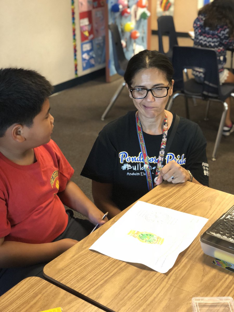 PonderosaPride's tweet photo. Pride: Critical Thinking At Work! Our Vice Principal, Ms. Gamez discusses with a Ponderosa engineer the function of his watch design... “Does it tell me the weather?” Family Days of Pride are awesome! #prideparented #ponderosapride #creatingdreams #buildingfutures https://t.co/kaomJyXCMp