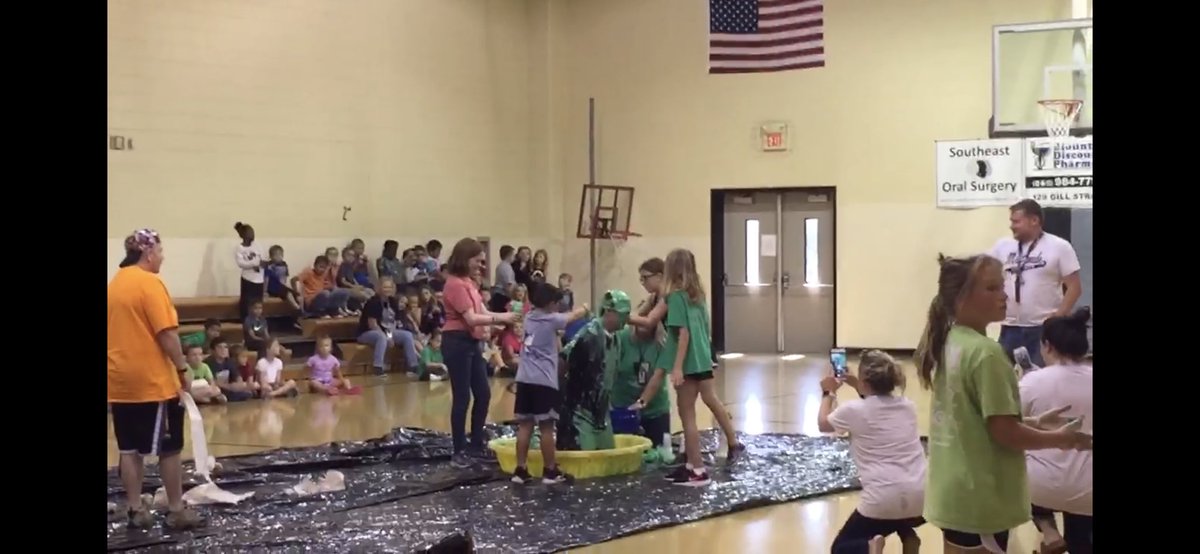 To celebrate selling 400 books today we held a candy drop where Mrs. Russell climbed on the roof and threw candy to coupon book sellers then the top 5 sellers in each grade them got to Slime Coach K!