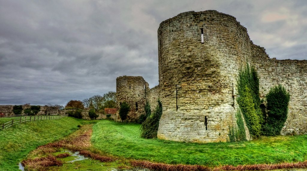 Pevensey Castle, East Sussex.

Built around 290 AD by the Romans and reoccupied in 1066 by the Normans, it had been abandoned by the late 16th century and remained a crumbling, partly overgrown ruin until it was acquired by the state in 1925.
