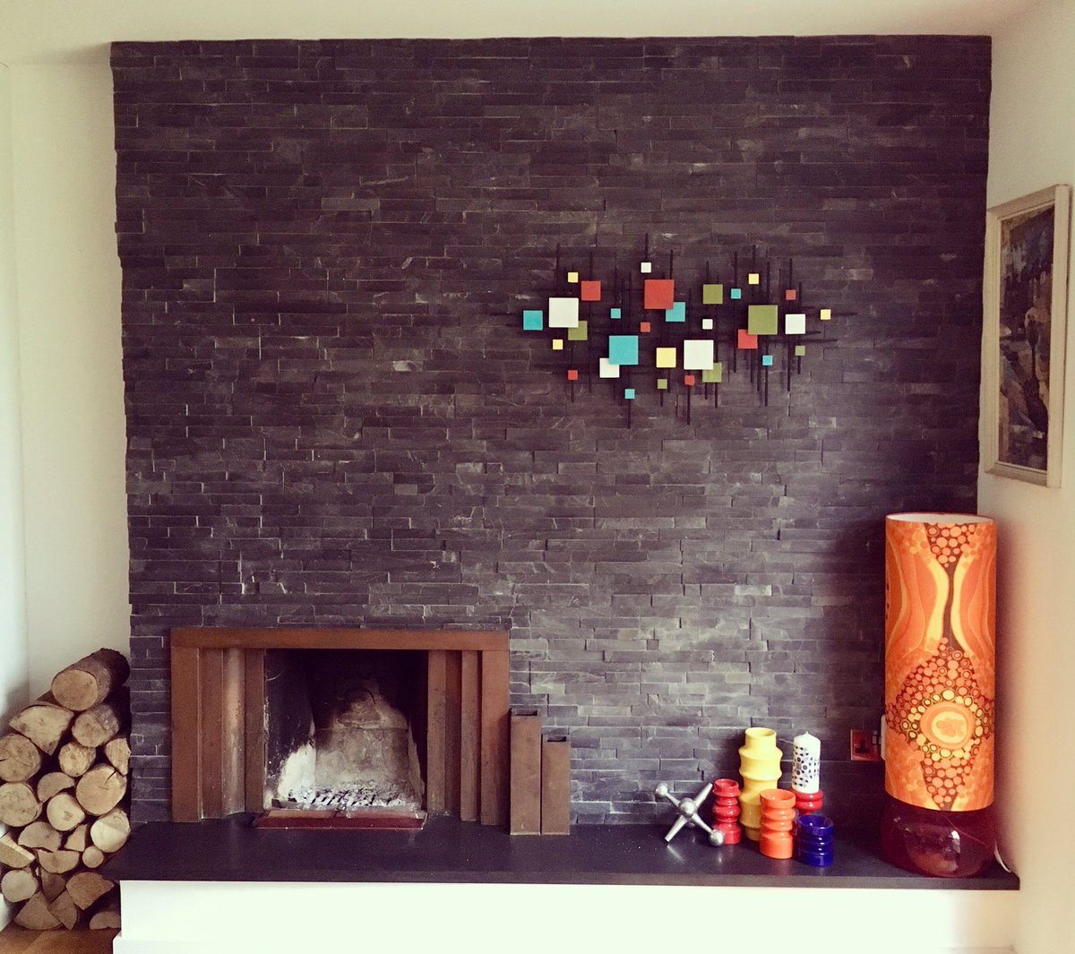 New metal-wall-sculpture-thing completes the 70s fireplace. #retrointeriors #70sdesign #fireplaces