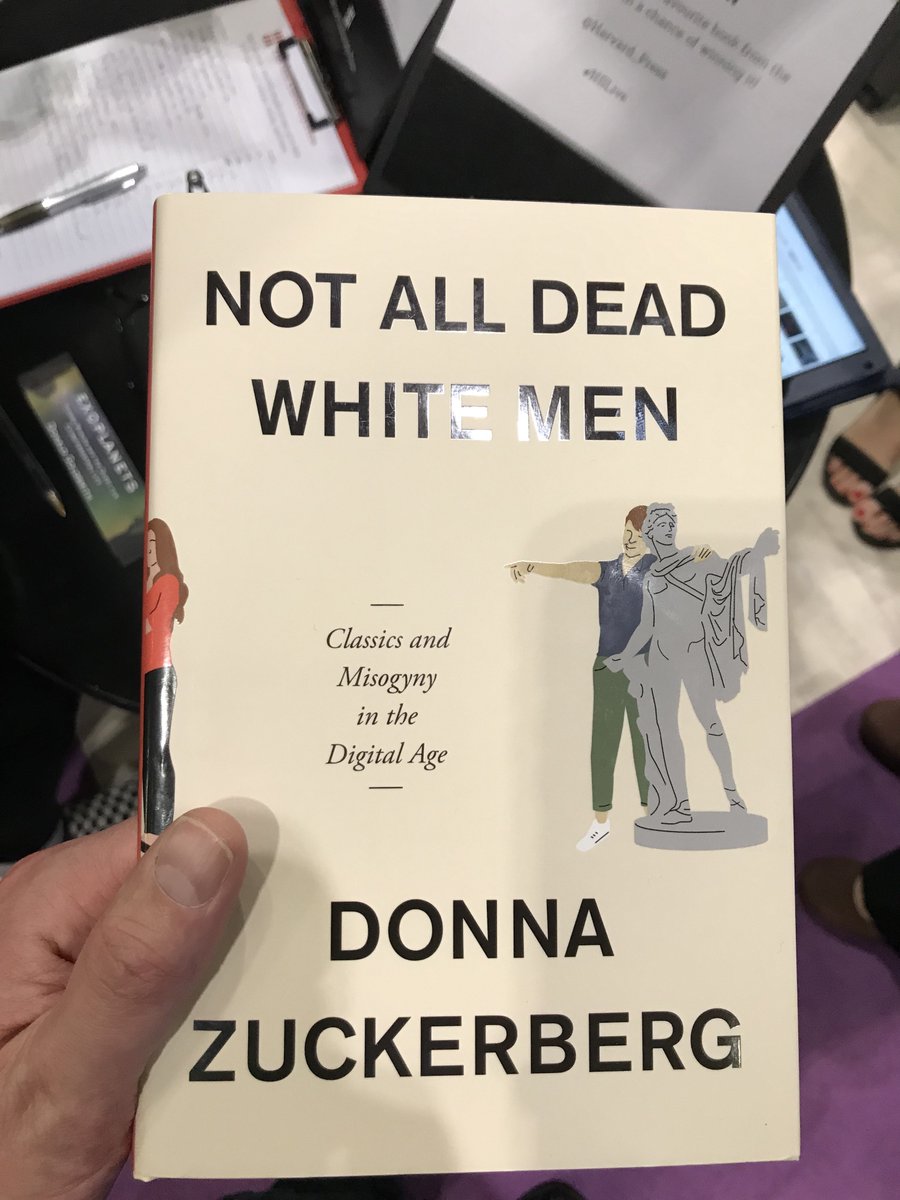 Book: Not all dead white men, by Donna Zuckerberg. subtitled "classics and misogyny in the digital age". Book jacket has a cartoon of a man dressed in jeans and a jumper talking to a classical sculpture while pointing at a woman in modern clothes.