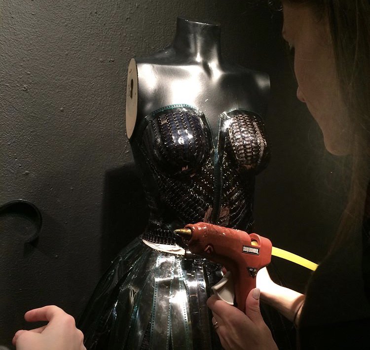 FIDM's tweet image. How cool is this dress made entirely out of film strips?! This window installation was created by @DallasCalhoun4 and her team mates in her #DesignInstallation class for #VisualCommunications. #StudentWorkSunday