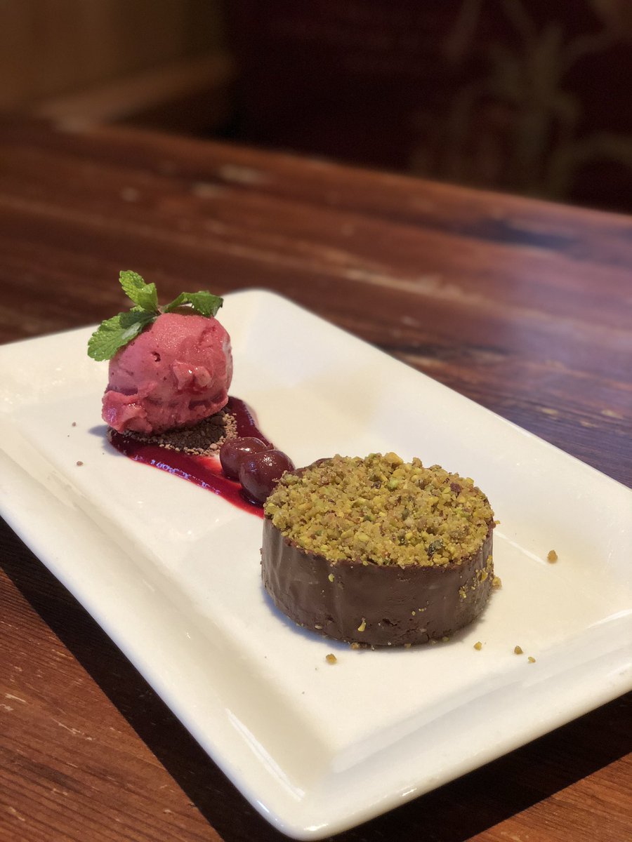 Dark chocolate torte with pistachio praline and cherry sorbet. Quickly becoming a new favourite pudding here 😋#pudding #chocolate #torte #pistachio #cherry #dessert