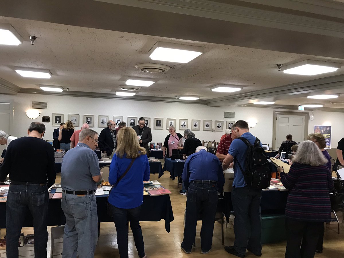 IHearofSherlock's tweet photo. A view from the very busy dealers room at the From Gillette to Brett V conference. Lots of Sherlockian stuff for sale! #G2BV https://t.co/eA3ehTa6oA