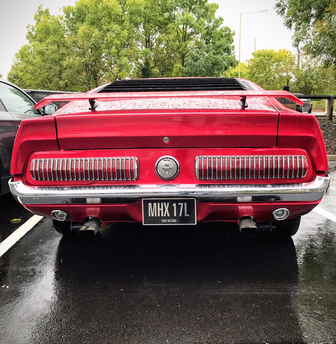 SirDivers's tweet photo. Fantastic spot at the supermarket. A 1972 #Ford #Mustang Mach 1 with the (probably) 351 Cleveland, candy apple red paint, and vintage #Halibrand style wheels. https://t.co/4IokkMUjVl