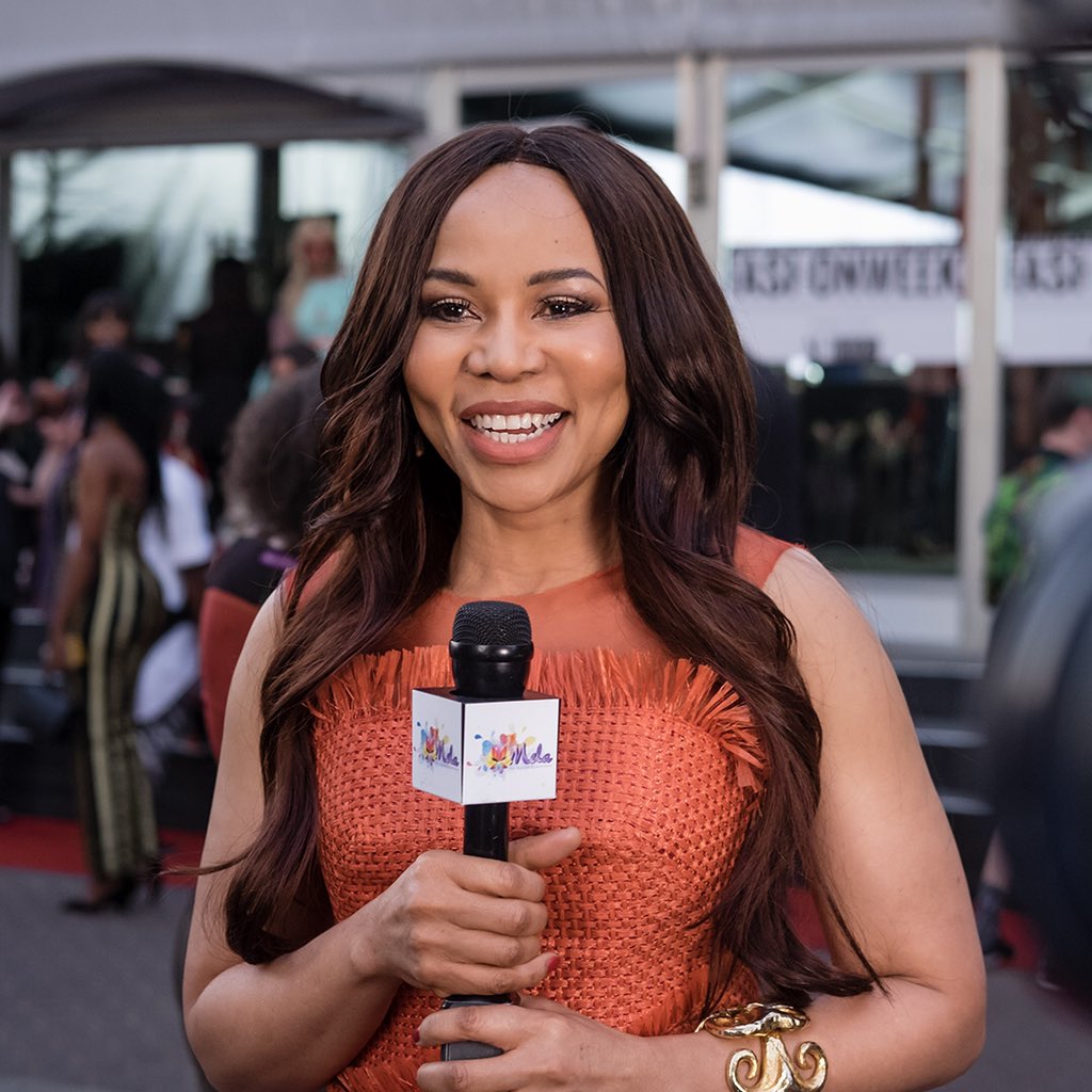 A vision in orange, Dr Precious Moloi Motsepe watches the Day 3 shows