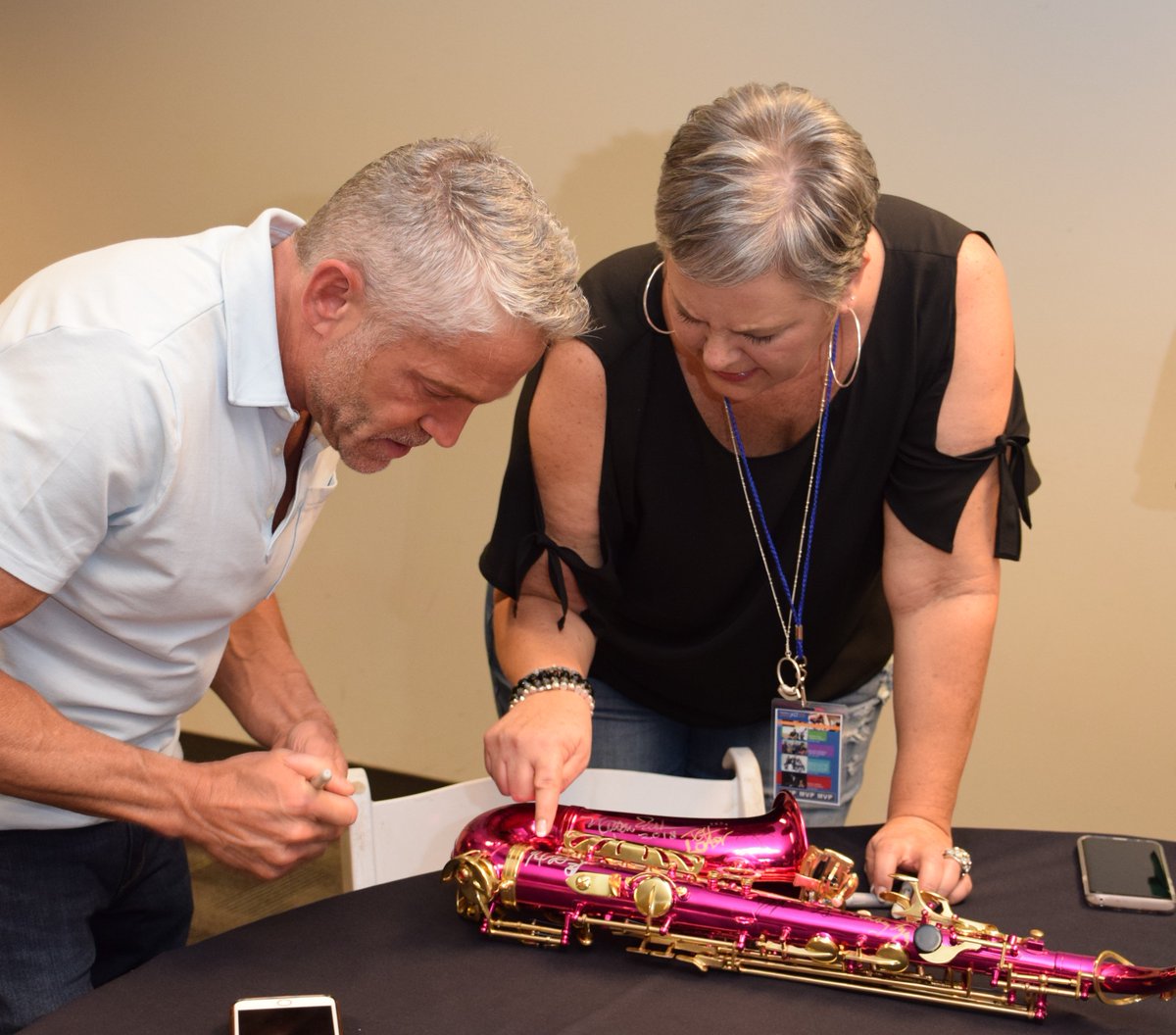 SaxOnTheRiver's tweet photo. Sax on the River Founder Trish Friend with @DaveKozMusic! Will you be going home with this priceless pink saxophone during the Sax on the River live auction? Signed by some of the world's greatest jazz talent! Get concert tickets here: https://t.co/xMVYwMxwRS https://t.co/aC9Q9RJMyF