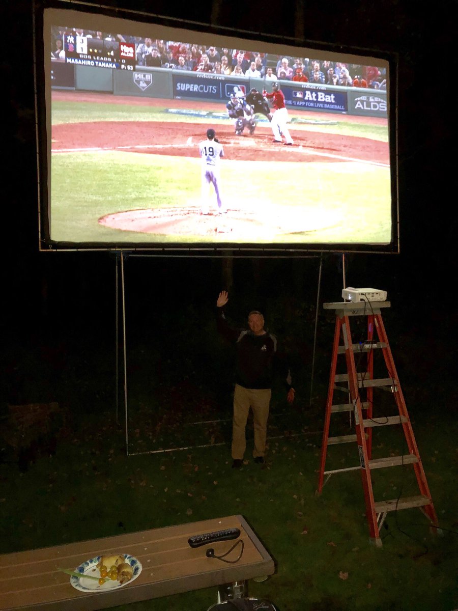 nhjoshjudge's tweet photo. How cool is this? We’re watching the Red Sox game at my brother-in Law’s house tonight. Check out this outdoor screen. That’s me underneath. It’s 214” diagonally!  Wow how fun. https://t.co/N6u5sPgIHl