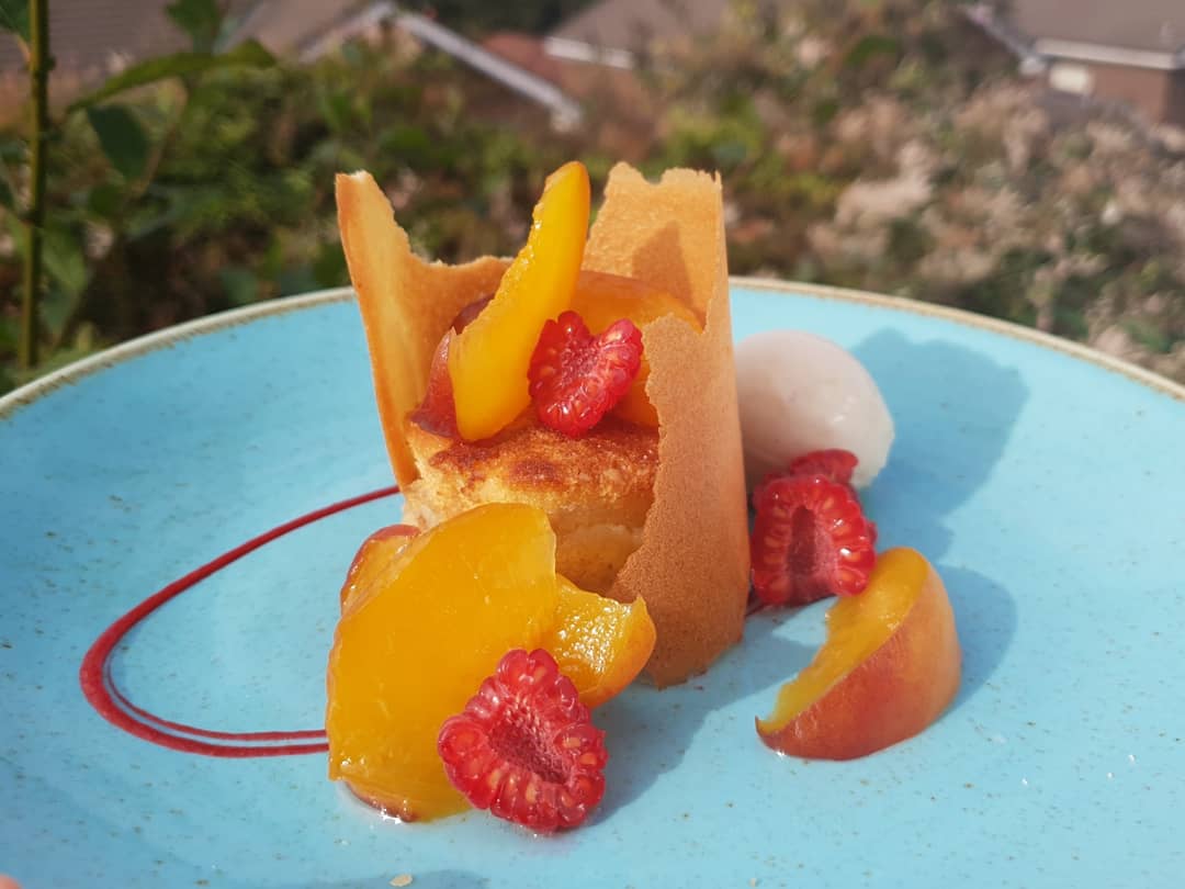 Peach Melba', Almond Pain Perdu, poached peaches, raspberry gel, tuile collar, peach caramel syrup and vanilla ice cream 🍑