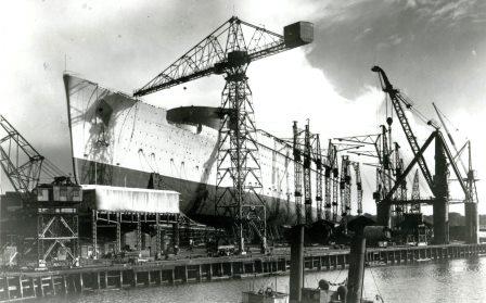 WDCHeritage's tweet photo. We're on a roll with maritime legends at the moment. Launched at #Clydebank today in 1934, the RMS Queen Mary. Here she is on the stocks and Queen Mary and King George ready to launch her. It was awfae dreich that day as well! #Cunard #MaritimeHistory #WeBuildLegends https://t.co/a3IYlmDCNR