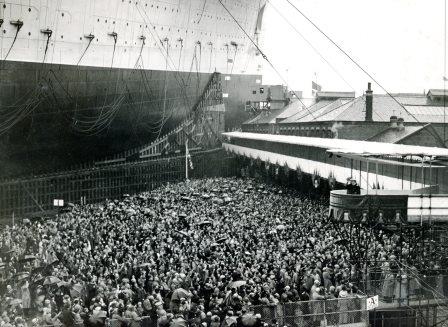 WDCHeritage's tweet photo. We're on a roll with maritime legends at the moment. Launched at #Clydebank today in 1934, the RMS Queen Mary. Here she is on the stocks and Queen Mary and King George ready to launch her. It was awfae dreich that day as well! #Cunard #MaritimeHistory #WeBuildLegends https://t.co/a3IYlmDCNR