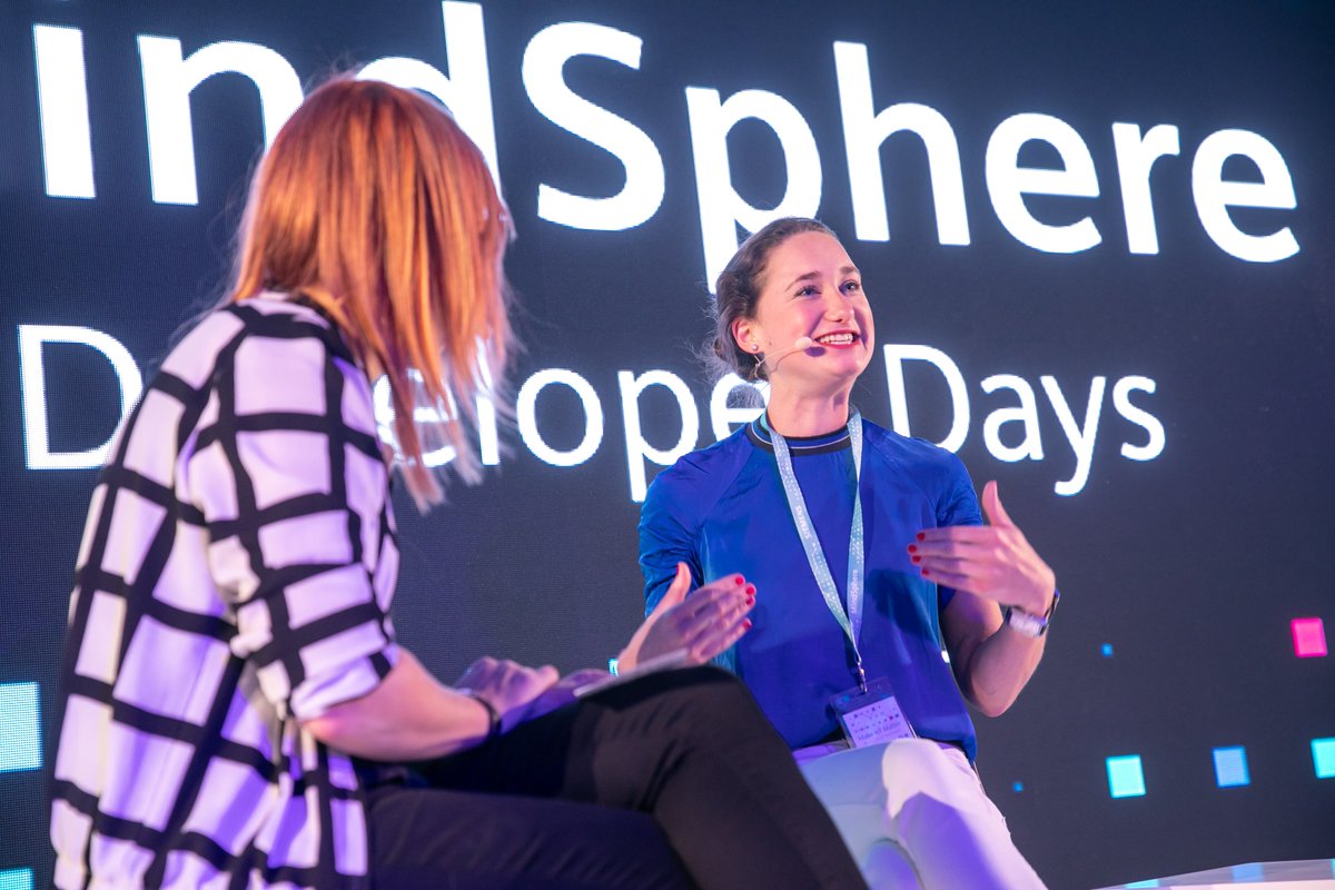 Siemens's tweet image. On stage is @KristinaDrenker, explaining why @CocaColaEP partners with #MindSphere in supply chain management. #DeveloperDays