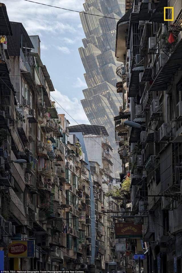 A truly astounding image. A street in Macau with the Grand Lisboa Casino looming in the background. Photograph by Paul Tsui, National Geographic travel photographer of the year.’ The future is now.