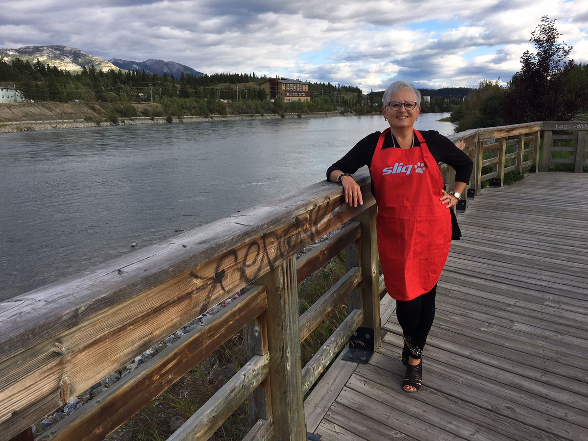 sliqmedia's tweet photo. Throwback to our dear friend Cheryl during #Hansard out in Yukon, wearing our #sliqaprons in front of a gorgeous backdrop. Thanks so much for helping us donate to the SPCA on your behalf! #sliqconferencetour18 #government #streaming https://t.co/AT1val30n0