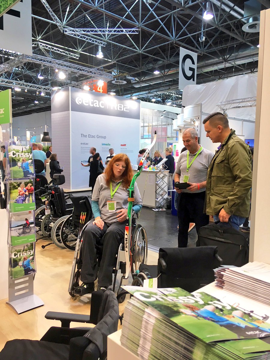 #Etac 2B back user and #Paralympic champion, Claudia Schäfers, shows how she rolls with bow and arrows to intrigued spectators <a href="/REHACARE/">REHACARE</a> etac.com/news/etac-grou… #Rehacare #creatingpossibilities