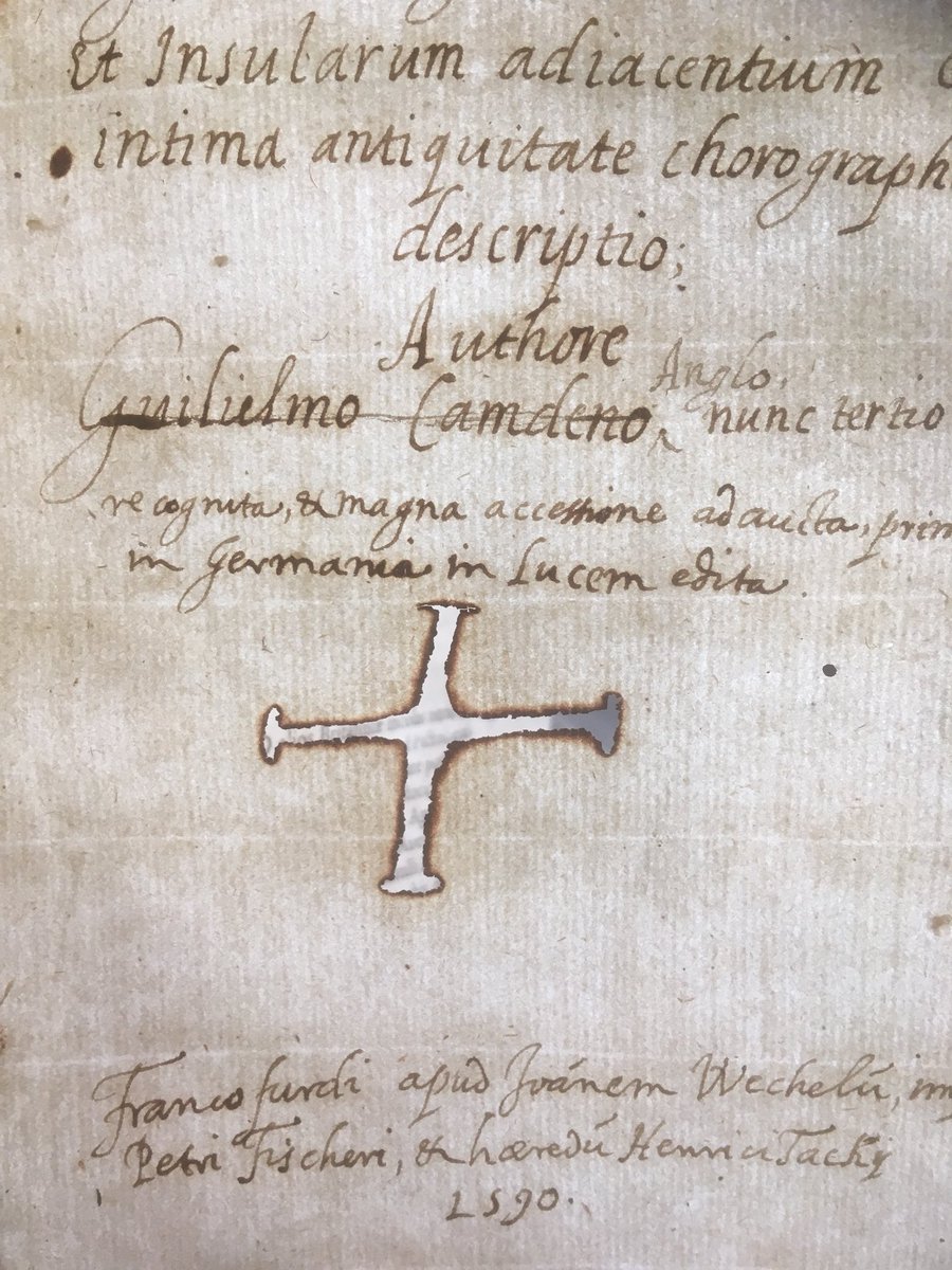 UshawLibrary's tweet photo. The #Lisbon collection keeps giving us some really interesting surprises. This book from 1590 has this interesting burnt cross in one of its cover pages, except we think that the paper had the shape of a cross soaked in ink which was then rubbed away. #LisbonLibrary #rarebooks https://t.co/VZv5CZRalF