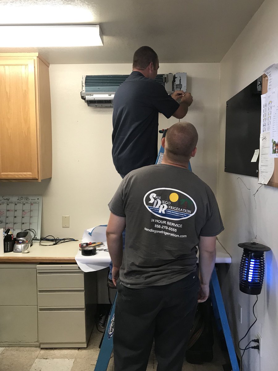 SC_NSD's tweet photo. Purchasing: M&amp;O Staff &amp; Contractor installing ductless     A/C unit inside warehouse office.#NSDnow https://t.co/PWApDdKSRo
