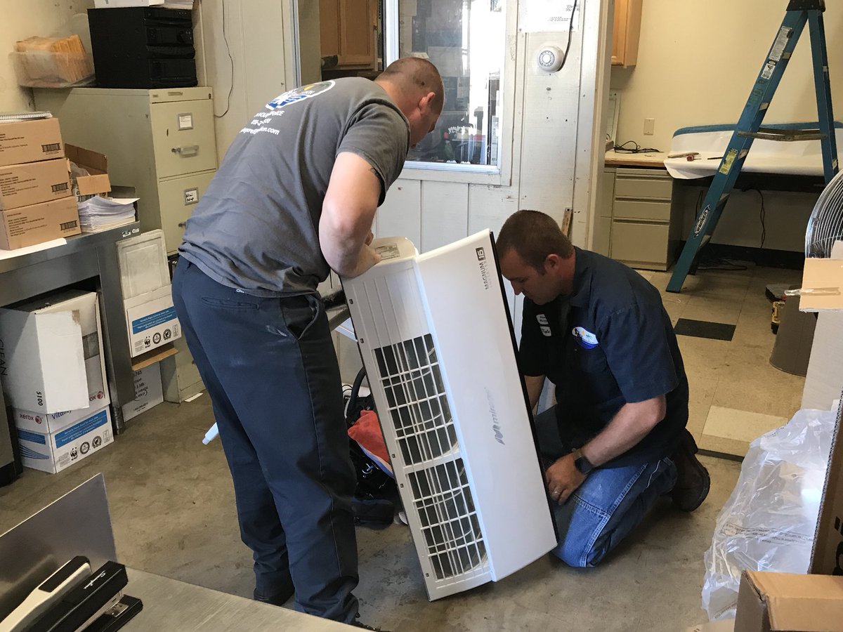 SC_NSD's tweet photo. Purchasing: M&amp;O Staff &amp; Contractor installing ductless     A/C unit inside warehouse office.#NSDnow https://t.co/PWApDdKSRo